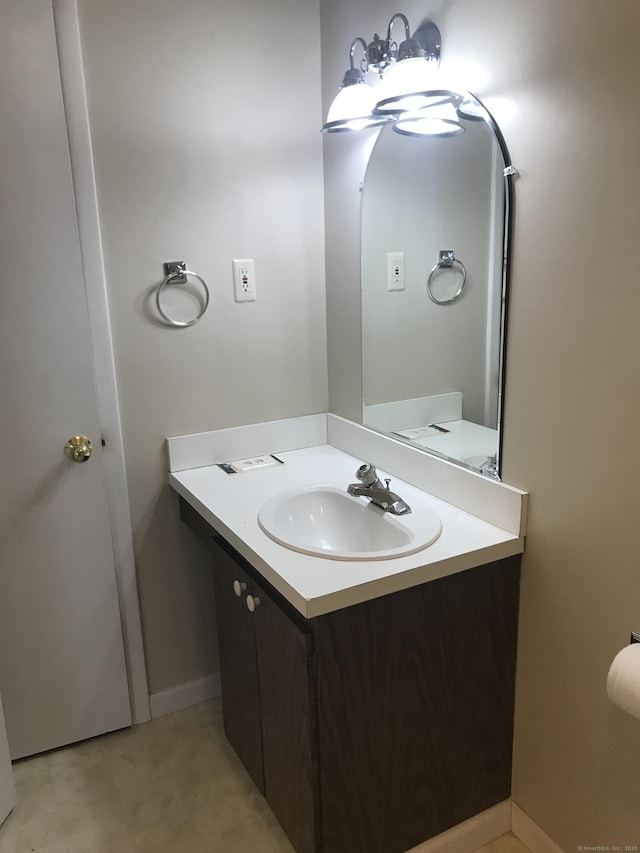 bathroom with vanity and baseboards
