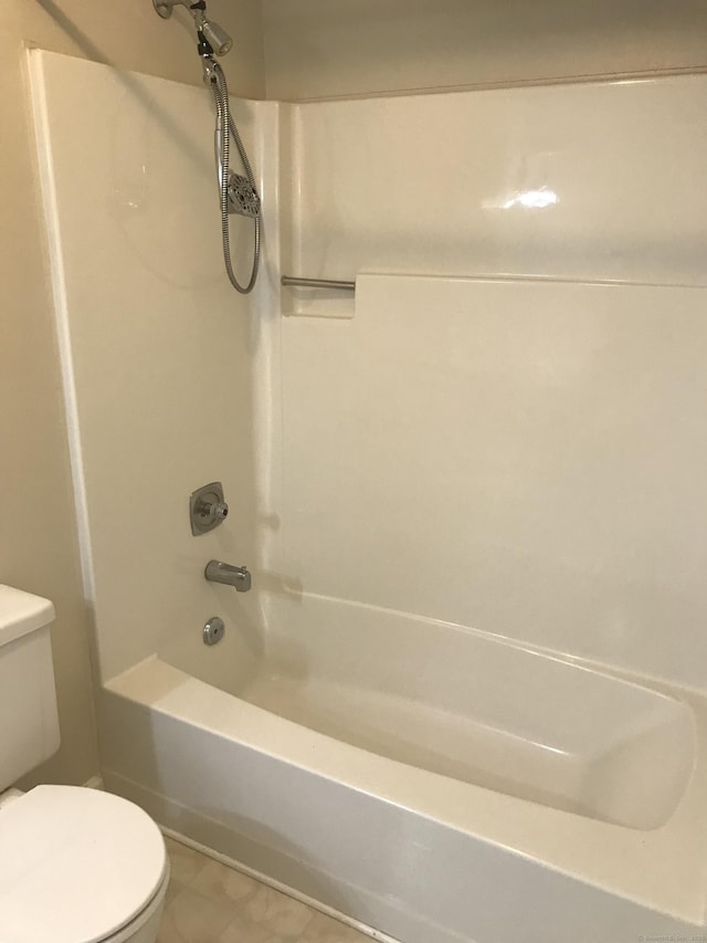 full bath featuring tile patterned floors, bathing tub / shower combination, and toilet
