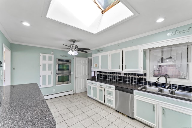 57 Bellevue Ter, Seymour, CT 06483 - kitchen with a baseboard heating unit, dark countertops, a skylight, stainless steel appliances, and a sink