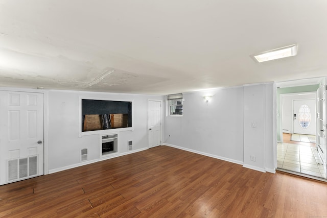 57 Bellevue Ter, Seymour, CT 06483 - unfurnished living room with visible vents, baseboards, baseboard heating, and wood finished floors