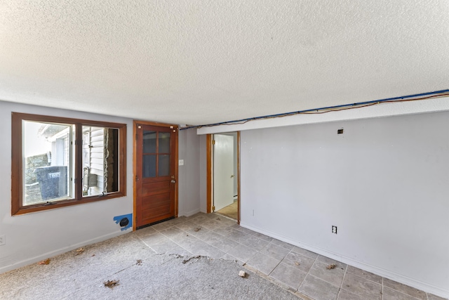57 Bellevue Ter, Seymour, CT 06483 - spare room featuring a textured ceiling, light tile patterned flooring, and baseboards