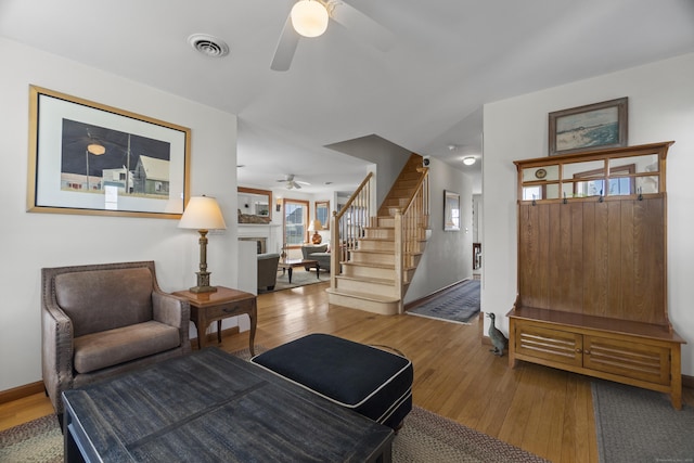 15 Buckingham Ave, Old Saybrook, CT 06475 - living room featuring ceiling fan, wood finished floors, stairway, and a fireplace