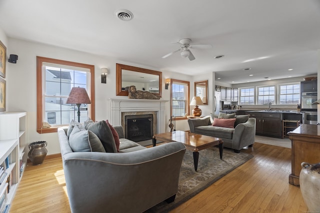 15 Buckingham Ave, Old Saybrook, CT 06475 - living room with a premium fireplace, light wood-style flooring, a ceiling fan, and recessed lighting