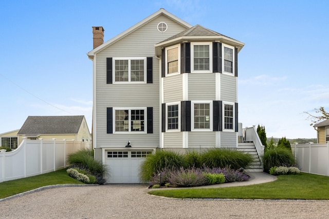 15 Buckingham Ave, Old Saybrook, CT 06475 - view of front of property featuring driveway, a garage, a chimney, and stairway