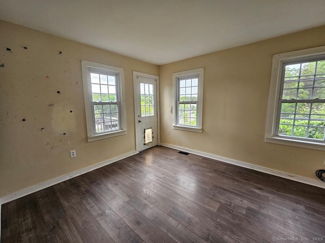 205 Flanders Rd, East Lyme, CT 06357 - spare room featuring plenty of natural light, dark wood finished floors, and baseboards