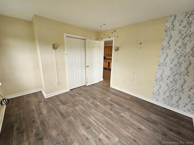 205 Flanders Rd, East Lyme, CT 06357 - unfurnished bedroom featuring wood finished floors, baseboards, and a closet