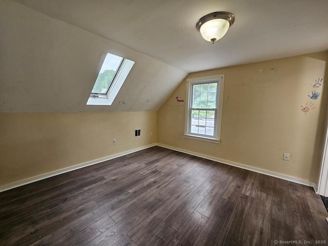 205 Flanders Rd, East Lyme, CT 06357 - bonus room featuring baseboards, dark wood-style floors, lofted ceiling, and a skylight