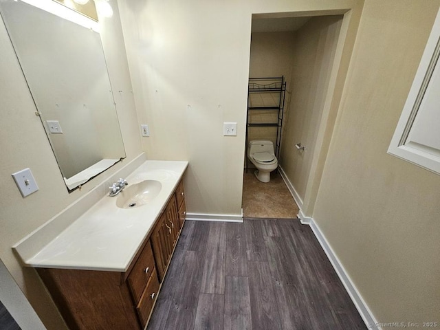 205 Flanders Rd, East Lyme, CT 06357 - bathroom featuring toilet, wood finished floors, vanity, and baseboards