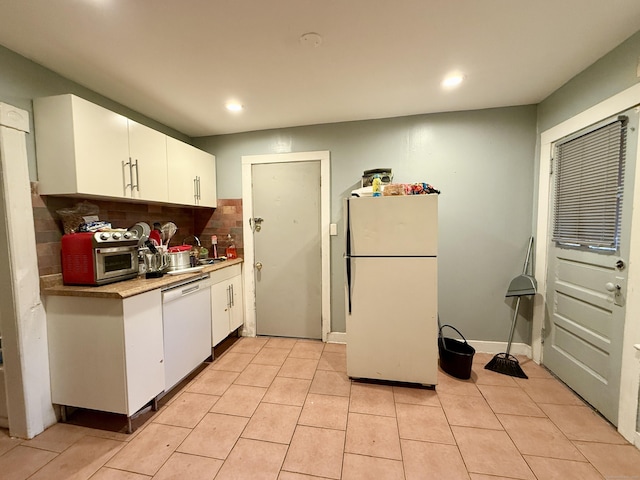 kitchen featuring tasteful backsplash, light tile patterned floors, white appliances, white cabinetry, and recessed lighting
