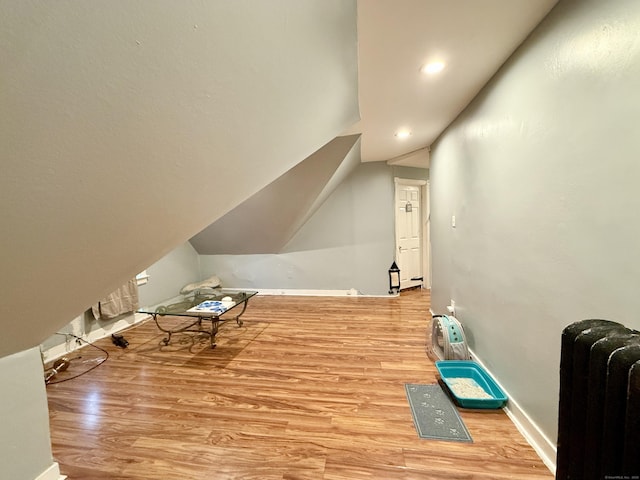 bonus room featuring wood finished floors, baseboards, vaulted ceiling, and recessed lighting