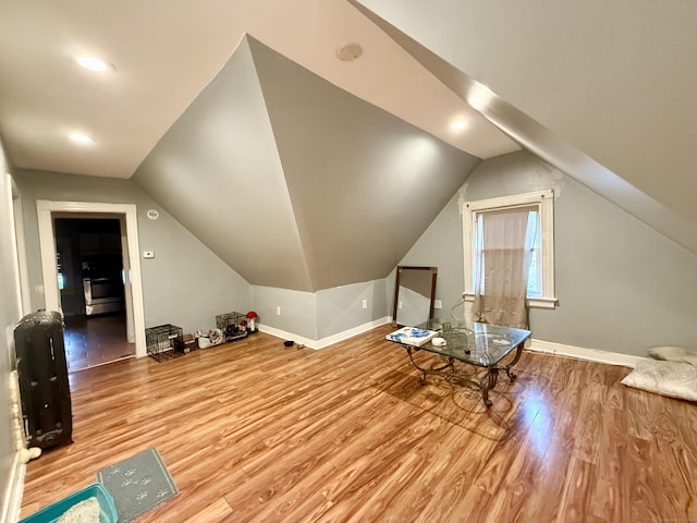 bonus room featuring wood finished floors, baseboards, lofted ceiling, and recessed lighting
