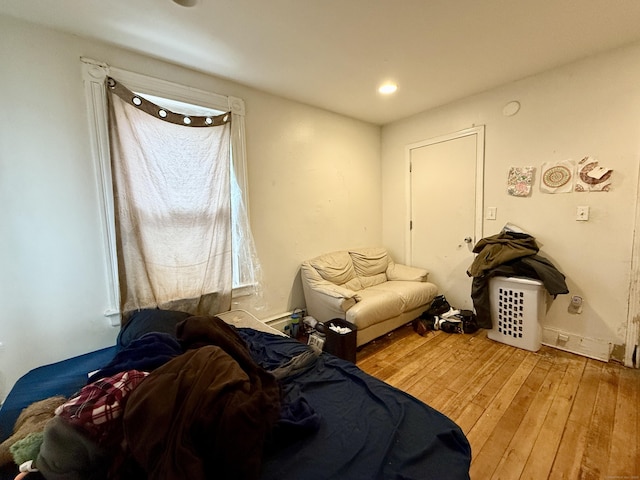 bedroom with wood finished floors and recessed lighting