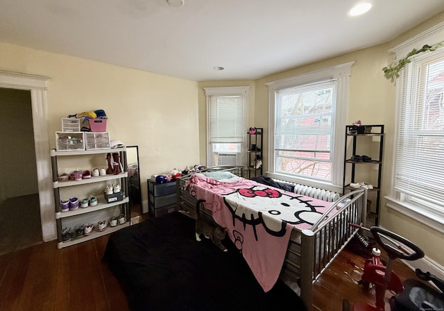 bedroom featuring wood finished floors, multiple windows, and recessed lighting
