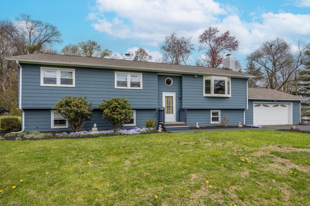 60 Pace Dr, Cheshire, CT 06410 - raised ranch featuring a front lawn, a chimney, a garage, and aphalt driveway