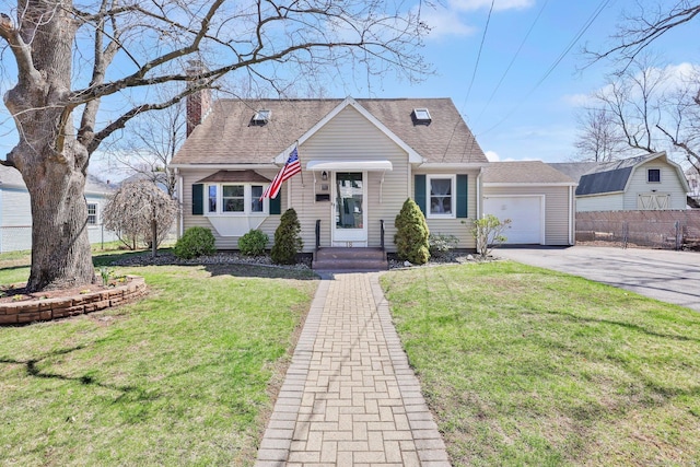 view of front of house featuring a garage, driveway, a front yard, and fence