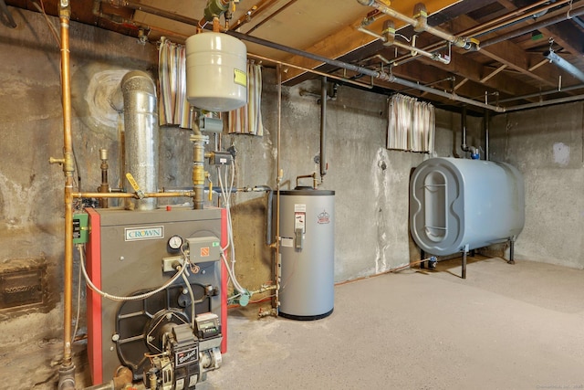 utility room featuring water heater, a heating unit, and heating fuel