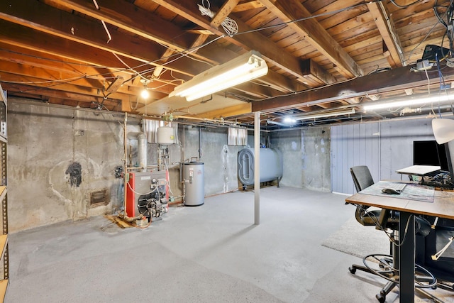 unfinished below grade area featuring water heater, a heating unit, and heating fuel