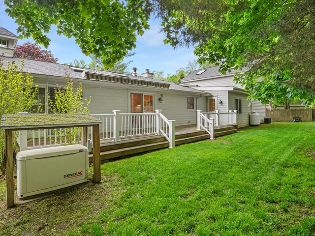 8 Argentine Way, Norwalk, CT 06850 - rear view of property with a wooden deck, a lawn, central AC unit, a chimney, and roof with shingles