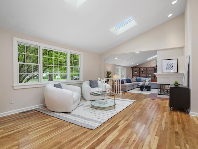 8 Argentine Way, Norwalk, CT 06850 - living area with a skylight, wood finished floors, healthy amount of natural light, vaulted ceiling, and a fireplace