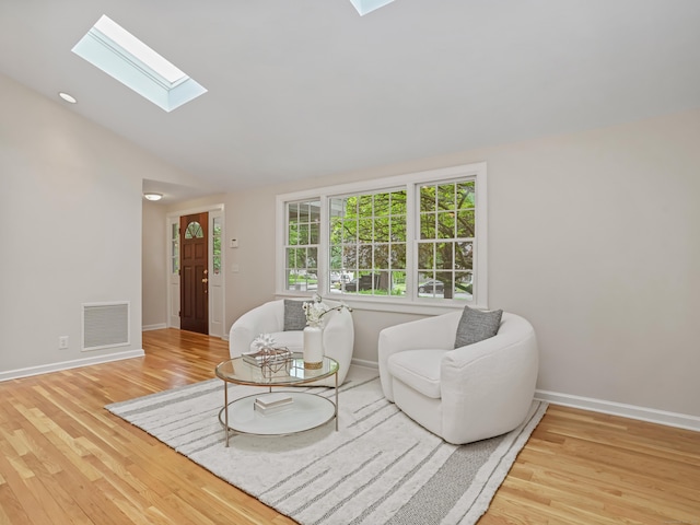 8 Argentine Way, Norwalk, CT 06850 - living area with a skylight, lofted ceiling, wood finished floors, and baseboards