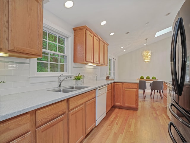 8 Argentine Way, Norwalk, CT 06850 - kitchen with freestanding refrigerator, white dishwasher, a sink, vaulted ceiling, and a peninsula