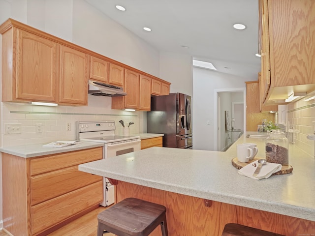 8 Argentine Way, Norwalk, CT 06850 - kitchen featuring black fridge with ice dispenser, white range with electric stovetop, under cabinet range hood, a peninsula, and a breakfast bar area