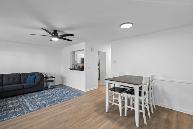 136 Pembroke Rd Unit 6-49, Danbury, CT 06811 - dining room featuring baseboards, ceiling fan, and wood finished floors