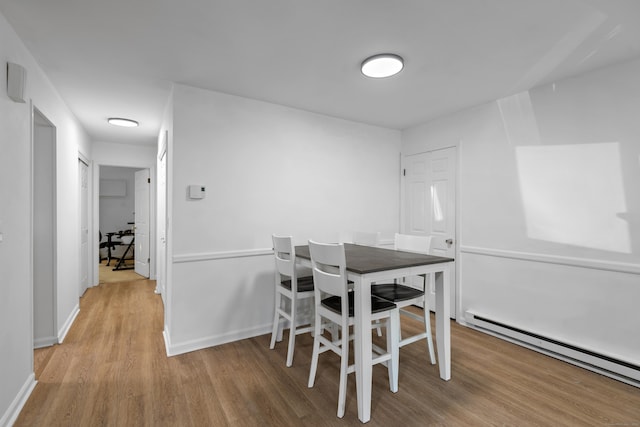 136 Pembroke Rd Unit 6-49, Danbury, CT 06811 - dining area featuring baseboards, a baseboard heating unit, and light wood-type flooring
