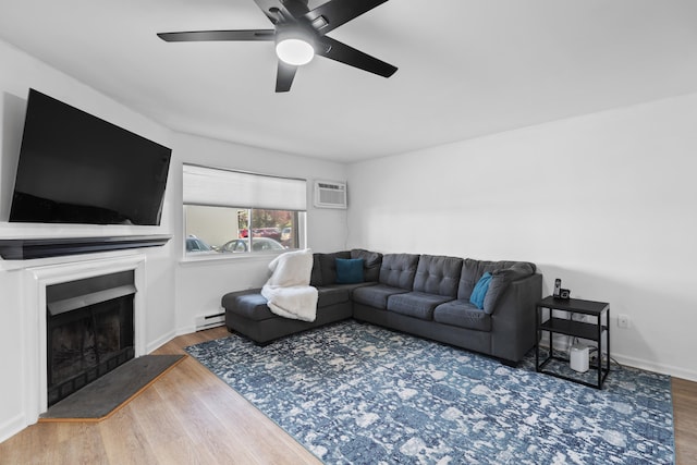 136 Pembroke Rd Unit 6-49, Danbury, CT 06811 - living area featuring a baseboard radiator, ceiling fan, wood finished floors, and a fireplace