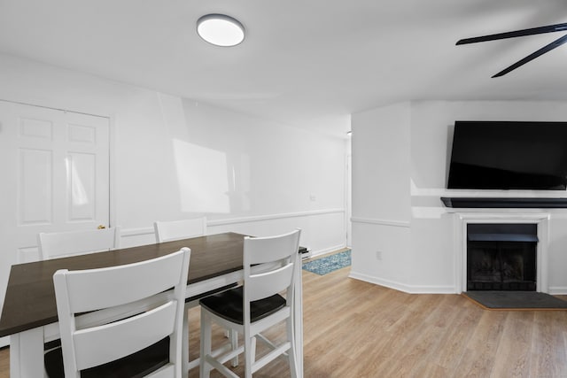 136 Pembroke Rd Unit 6-49, Danbury, CT 06811 - dining space featuring baseboards, a fireplace, a ceiling fan, and wood finished floors