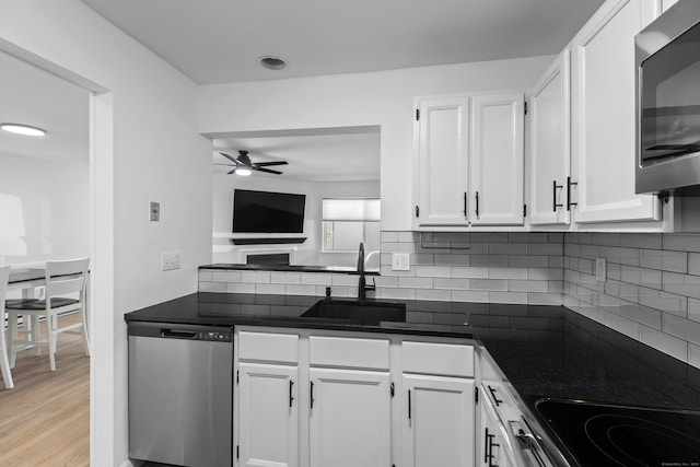 136 Pembroke Rd Unit 6-49, Danbury, CT 06811 - kitchen featuring a ceiling fan, a sink, white cabinetry, and stainless steel appliances