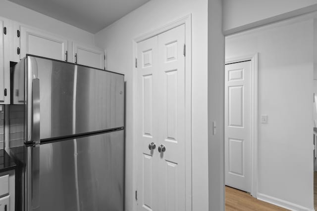 136 Pembroke Rd Unit 6-49, Danbury, CT 06811 - kitchen featuring white cabinets, freestanding refrigerator, and light wood-style flooring