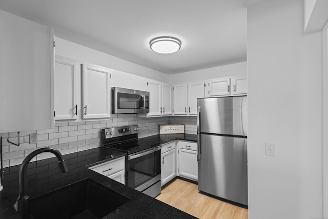 136 Pembroke Rd Unit 6-49, Danbury, CT 06811 - kitchen featuring a sink, white cabinetry, dark countertops, and stainless steel appliances