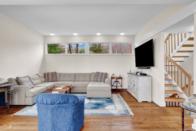 living room with recessed lighting, stairway, and light wood finished floors