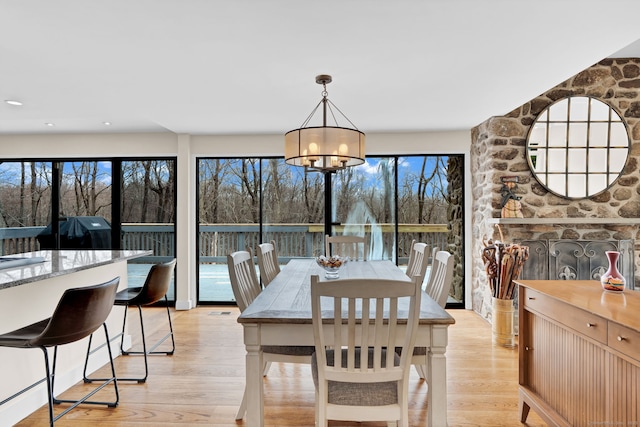 dining room featuring light wood-style flooring and an inviting chandelier