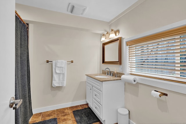 bathroom with baseboards, vanity, tile patterned floors, and visible vents