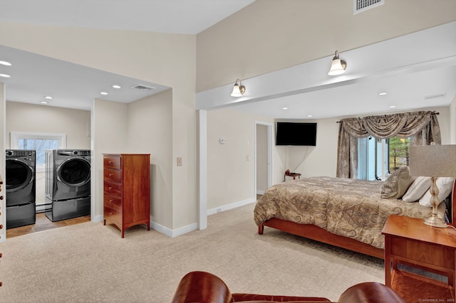 carpeted bedroom featuring recessed lighting, visible vents, washer and dryer, and multiple windows