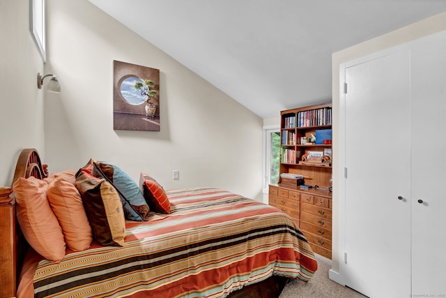 bedroom featuring vaulted ceiling and carpet flooring