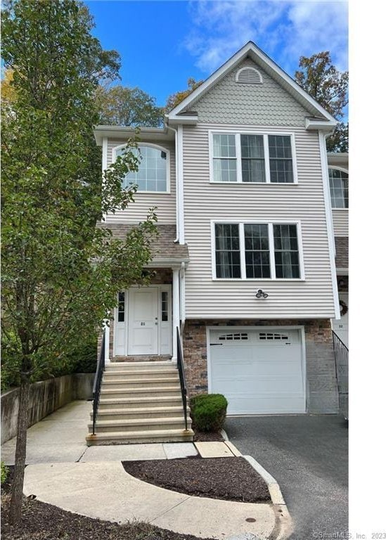 21 Old Oak Dr Unit 21, Brookfield, CT 06804 - view of front facade with an attached garage and aphalt driveway