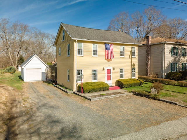 574 Fabyan Rd, Thompson, CT 06255 - colonial house featuring a detached garage, a chimney, an outdoor structure, and roof with shingles