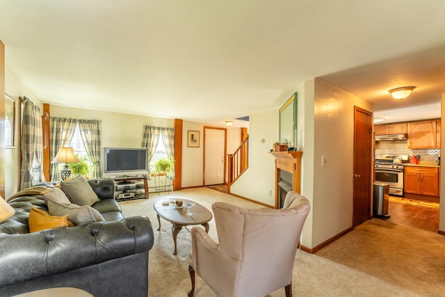574 Fabyan Rd, Thompson, CT 06255 - living area featuring baseboards, stairway, light carpet, and a fireplace