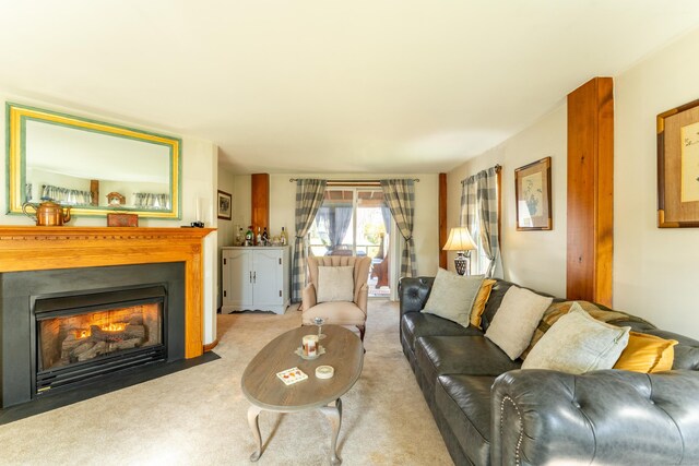 574 Fabyan Rd, Thompson, CT 06255 - living area featuring a fireplace with flush hearth and carpet flooring