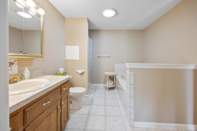 full bathroom with vanity, toilet, baseboards, tile patterned floors, and tiled bath