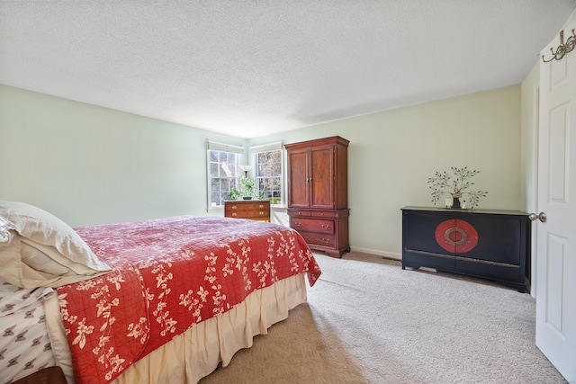 bedroom with carpet floors and a textured ceiling