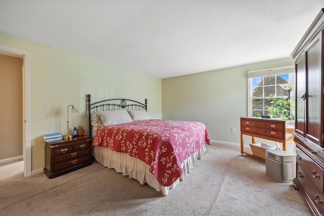 bedroom with carpet flooring, a textured ceiling, and baseboards