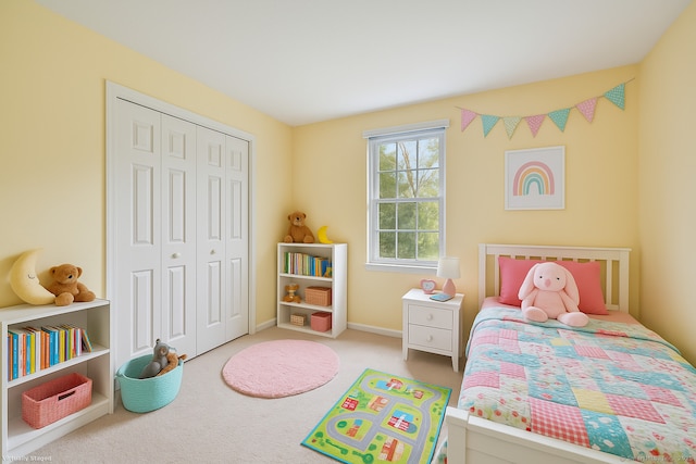 carpeted bedroom with a closet and baseboards