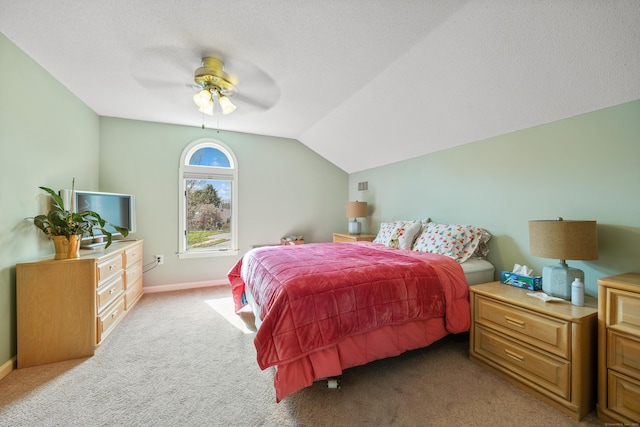 bedroom with baseboards, ceiling fan, light carpet, and lofted ceiling