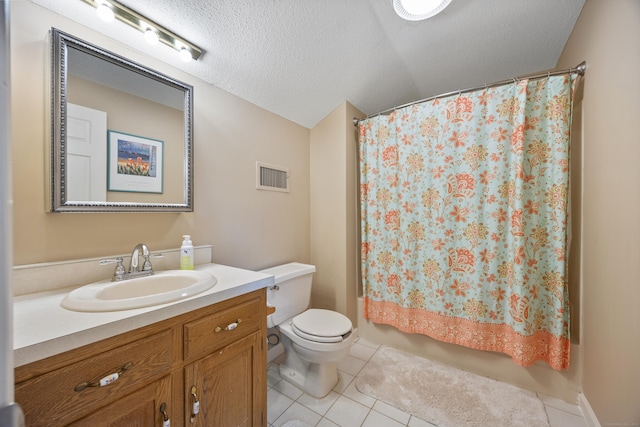 bathroom with visible vents, vanity, toilet, a textured ceiling, and tile patterned floors