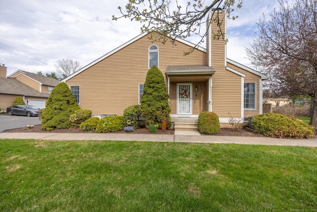 bungalow-style house with a chimney and a front lawn