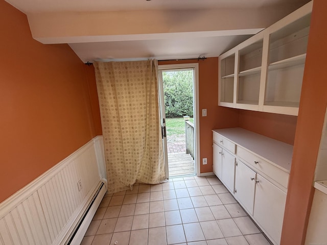 doorway with a baseboard radiator and light tile patterned flooring